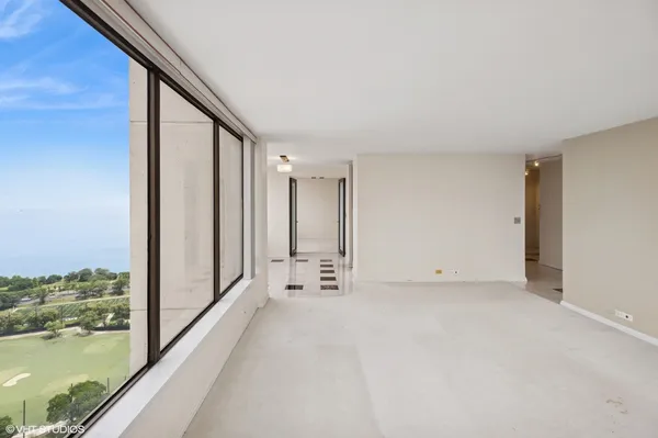 a view of empty room with lake view and mountain view