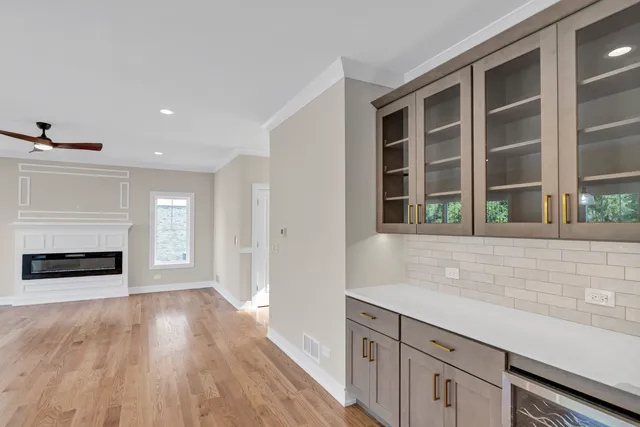 a view of wooden floor and a fireplace in a kitchen