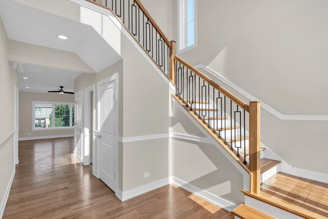 a view of staircase with wooden floor and a window