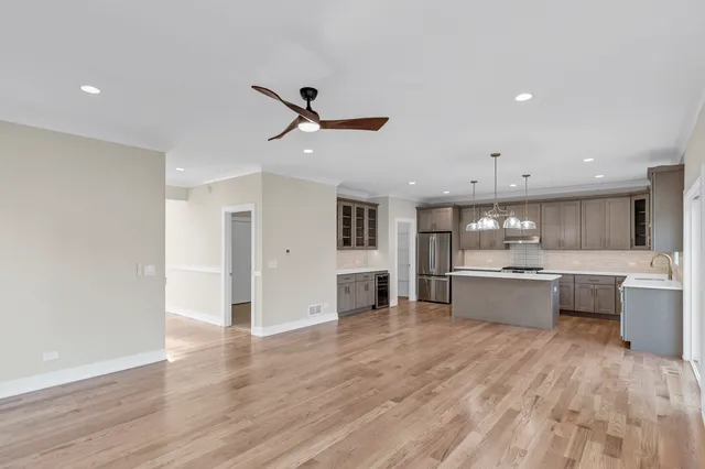 a large kitchen with a lot of counter space and a wooden floor