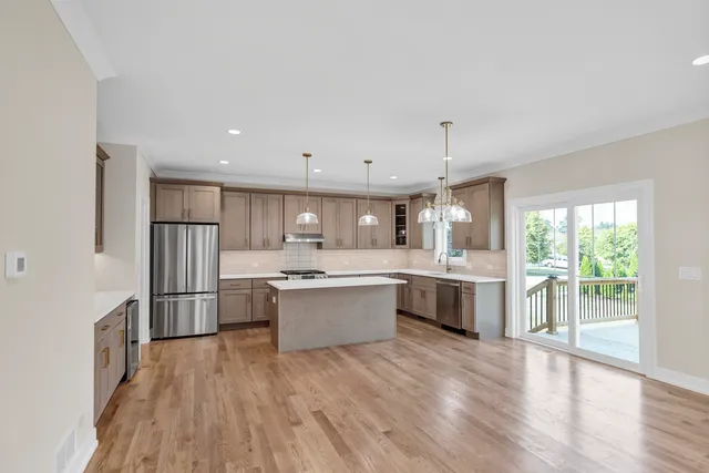 a large kitchen with a lot of counter space and stainless steel appliances