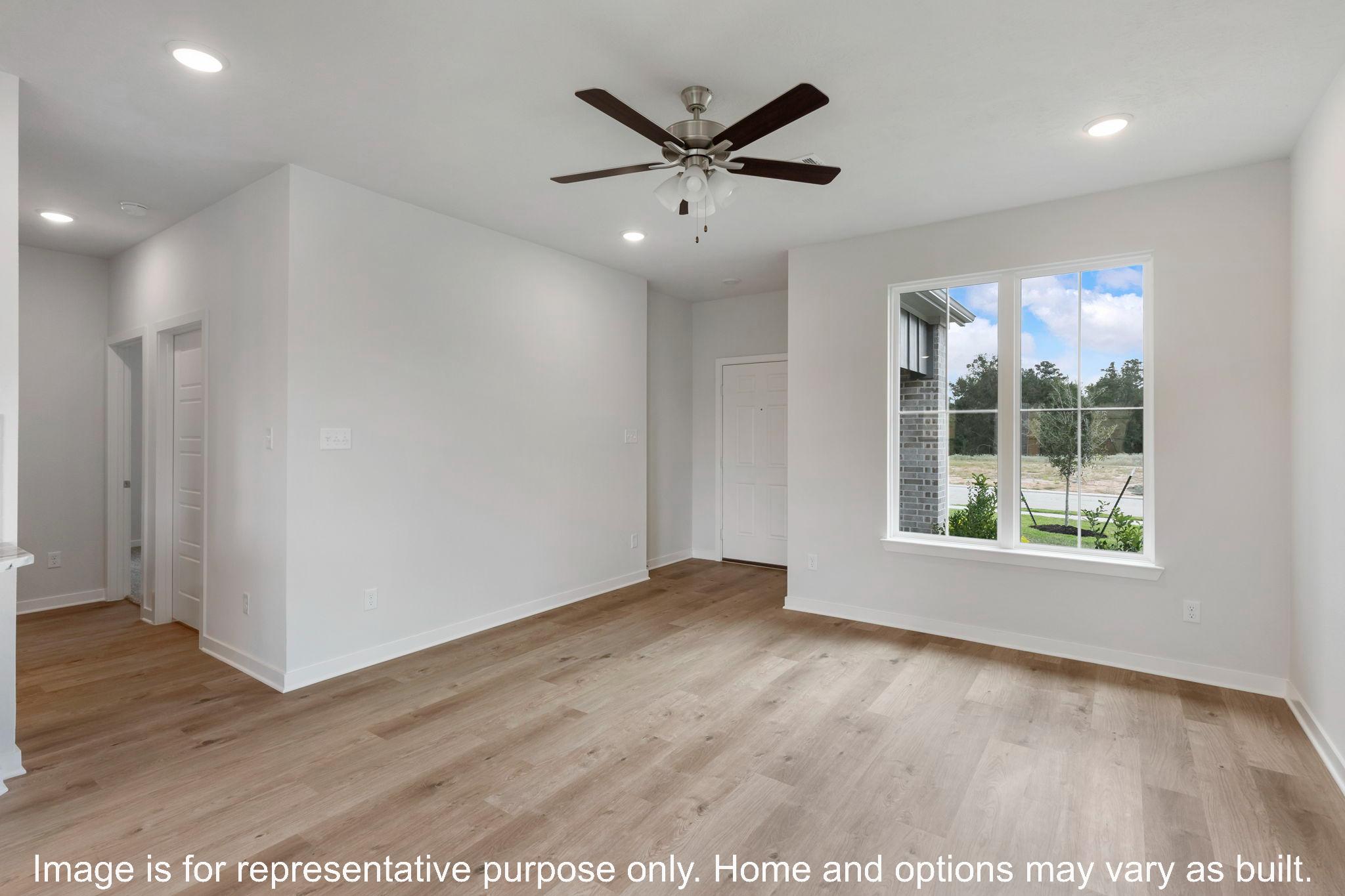 251 Gus Loop Georgetown, TX 78626 - Photo 5 of 10 A versatile open-concept living space features light-toned flooring and abundant natural light.
