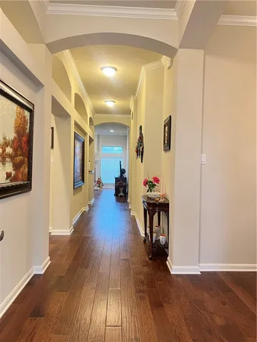 a view of a hallway view with wooden floor and dining room