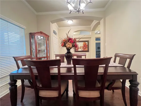 a view of a dining room with furniture and chandelier