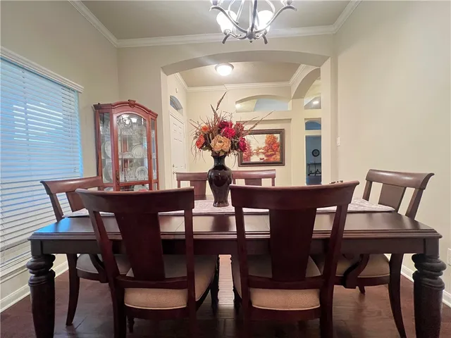 a view of a dining room with furniture and chandelier