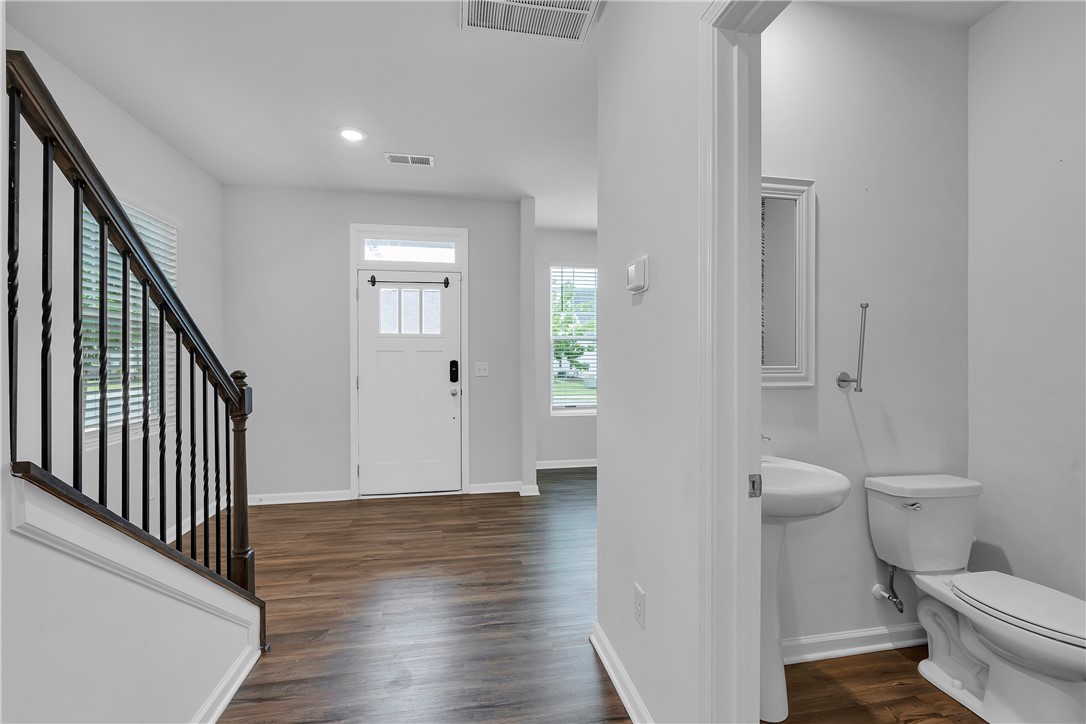 8 Leander Drive Greer, SC 29651 - Photo 14 of 31 Rich hardwood flooring leads into a well-appointed entry with a convenient half bathroom.
