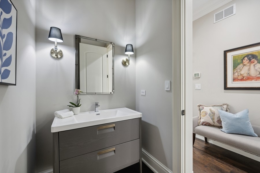 2 Bristol Road Northfield, IL 60093 - Photo 17 of 52 a bathroom with a sink and a mirror