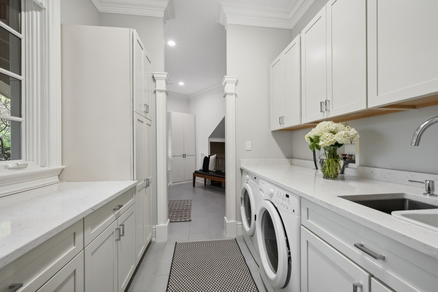 2 Bristol Road Northfield, IL 60093 - Photo 23 of 52 a kitchen with a sink and a washer dryer