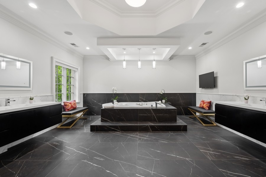 2 Bristol Road Northfield, IL 60093 - Photo 26 of 52 a living room with furniture a flat screen tv and a window