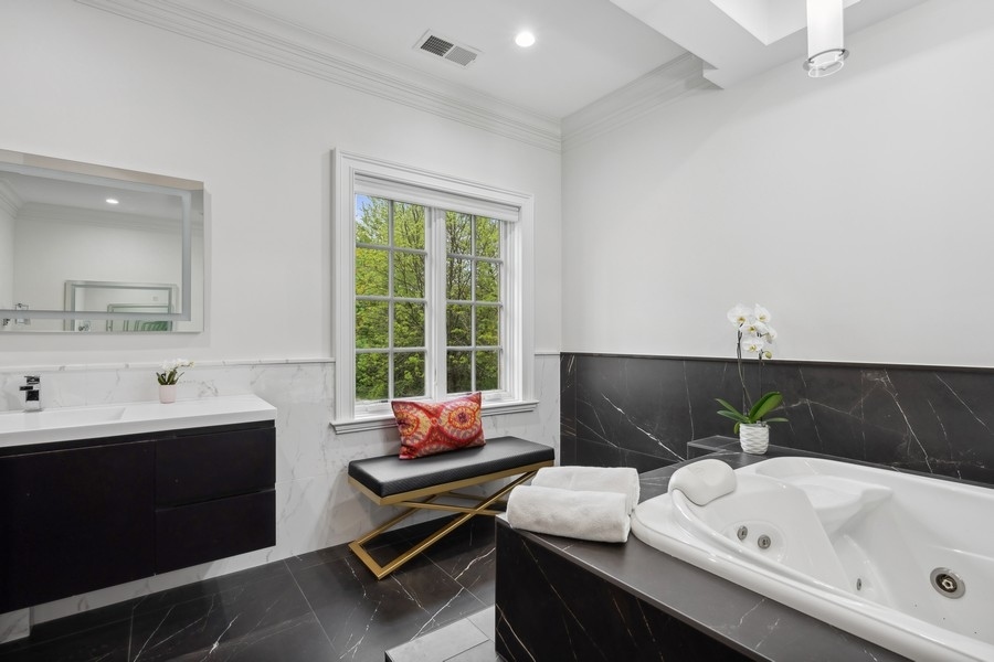 2 Bristol Road Northfield, IL 60093 - Photo 27 of 52 a bathroom with a sink and a bathtub