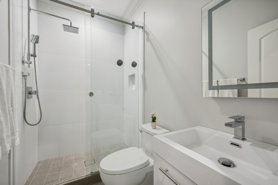 2 Bristol Road Northfield, IL 60093 - Photo 31 of 52 a bathroom with a sink a toilet and shower