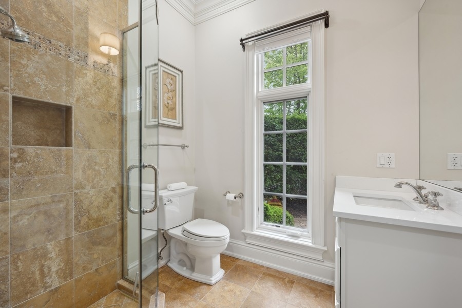 2 Bristol Road Northfield, IL 60093 - Photo 33 of 52 a white toilet sitting next to a bathroom sink