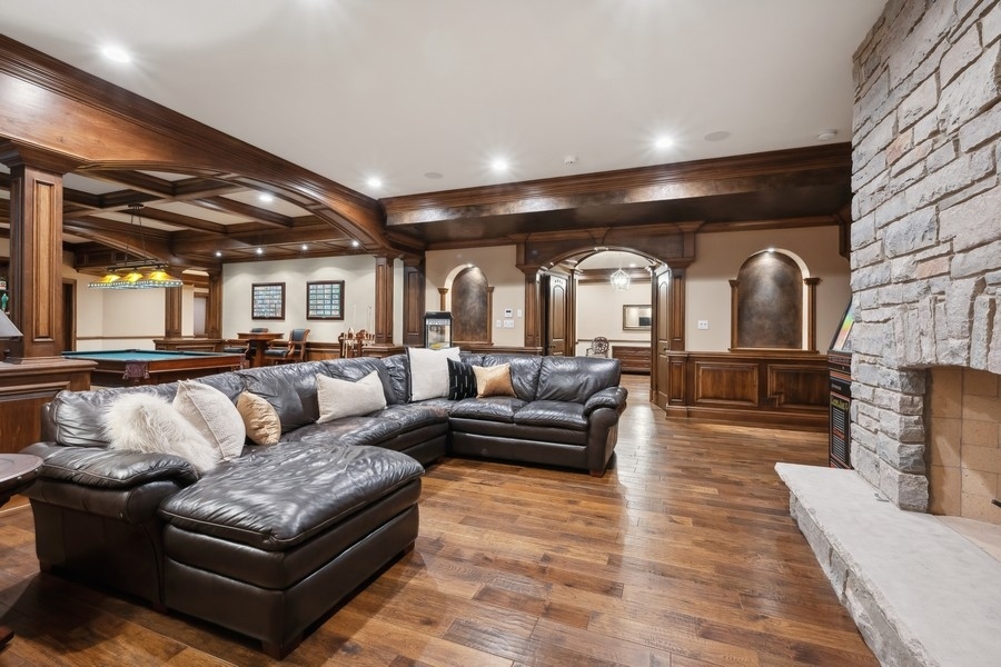 2 Bristol Road Northfield, IL 60093 - Photo 36 of 52 a living room with couches and kitchen view with wooden floor