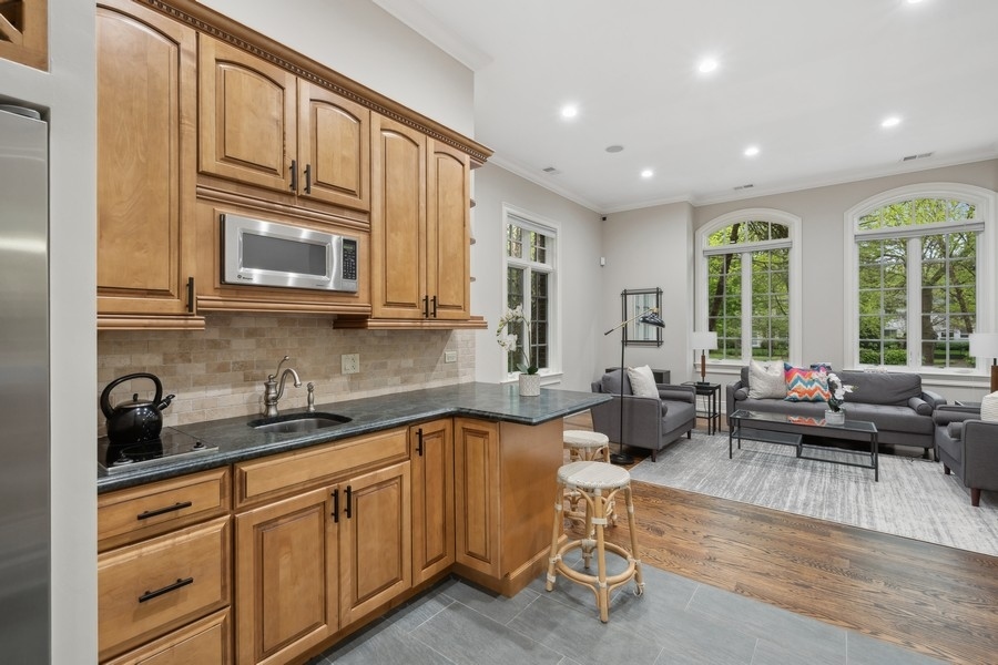 2 Bristol Road Northfield, IL 60093 - Photo 43 of 52 a kitchen with stainless steel appliances granite countertop a stove a sink and a microwave