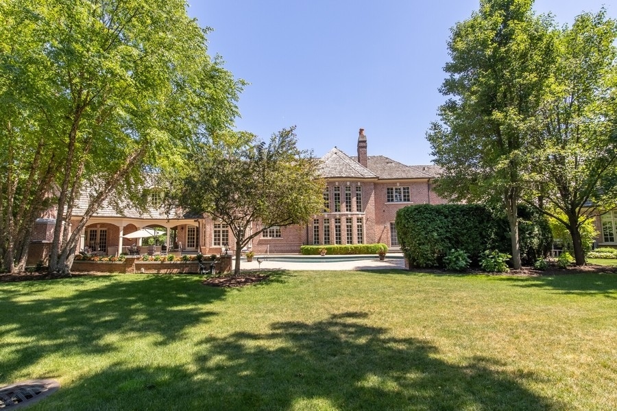 2 Bristol Road Northfield, IL 60093 - Photo 51 of 52 a view of a house with a big yard and large trees