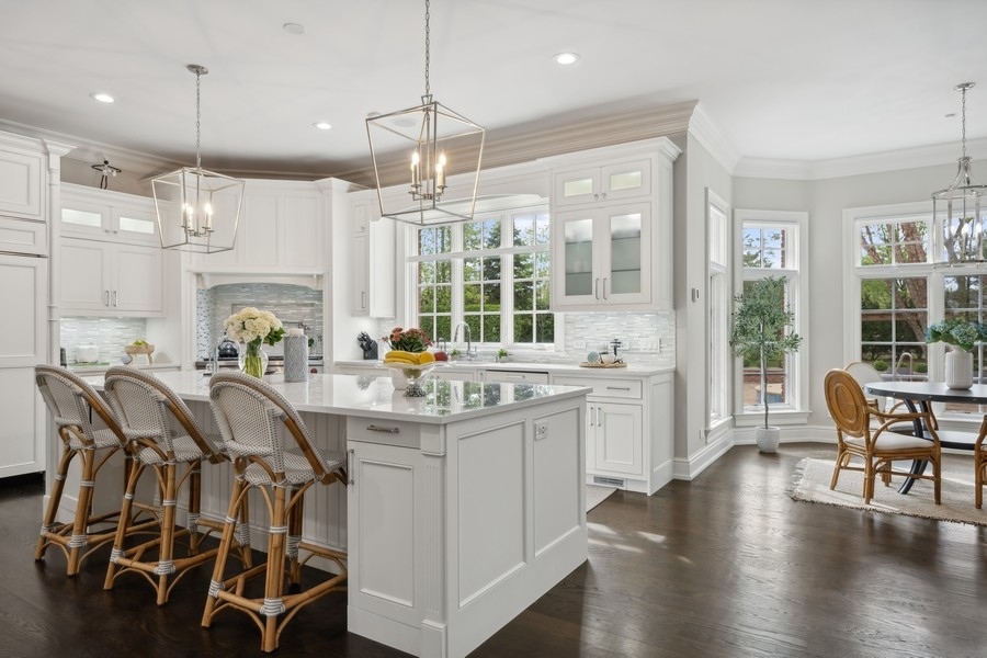 2 Bristol Road Northfield, IL 60093 - Photo 10 of 52 a kitchen with a table chairs stove and wooden floor