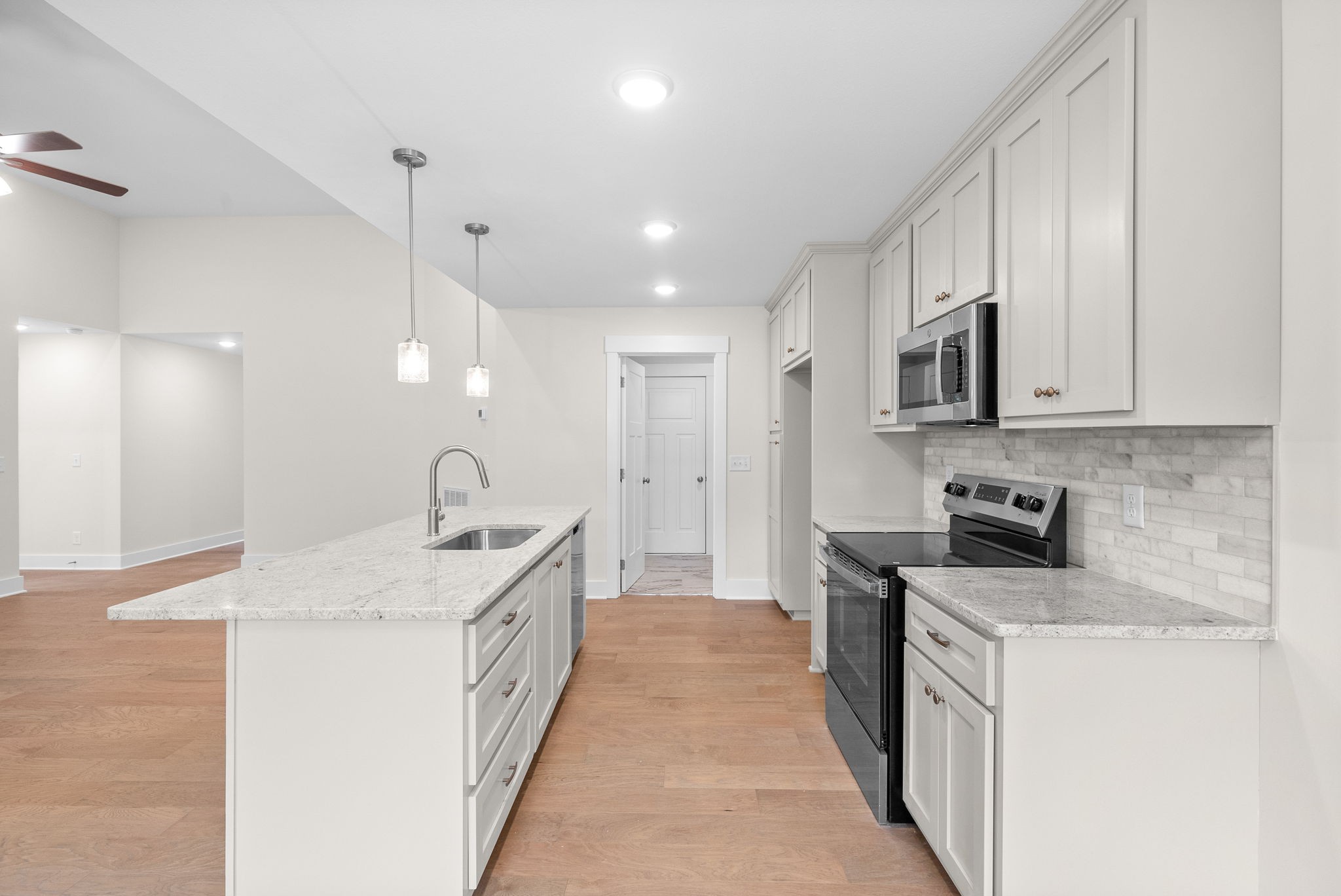 1928 Flats Road Cunningham, TN 37052 - Photo 16 of 49 a open kitchen with stainless steel appliances granite countertop a sink and dishwasher a stove with wooden floor