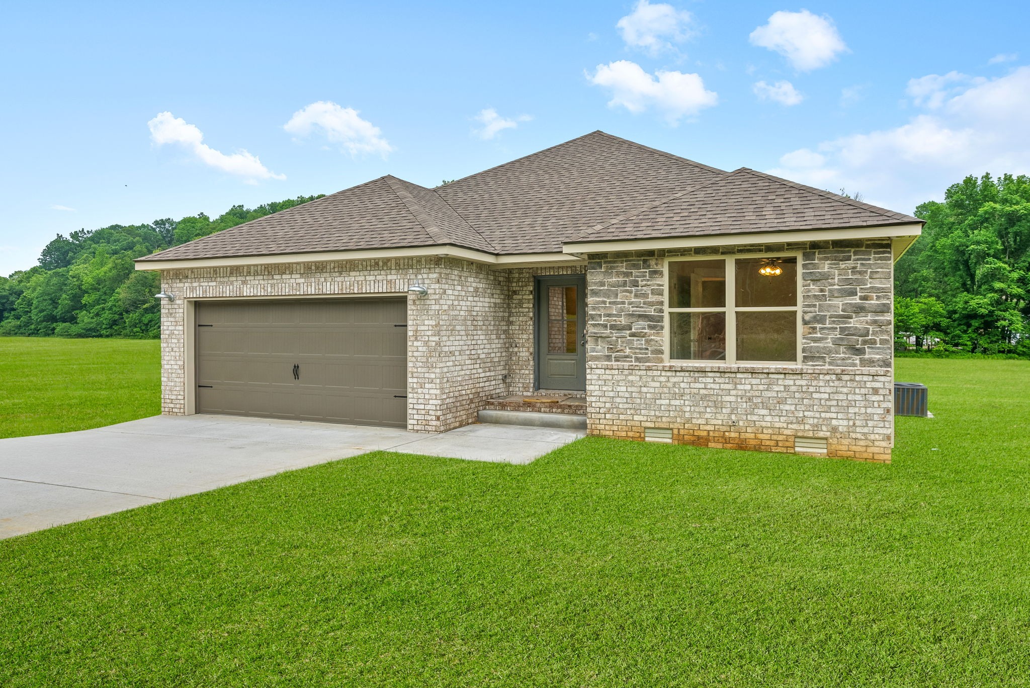 1928 Flats Road Cunningham, TN 37052 - Photo 5 of 49 a front view of a house with a yard and garage