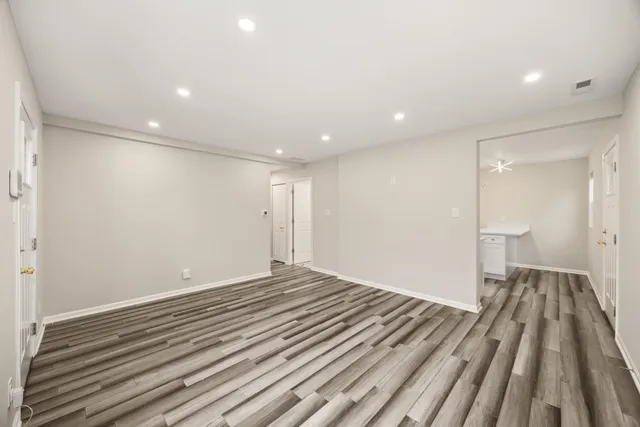 a view of a room with wooden floor and closet