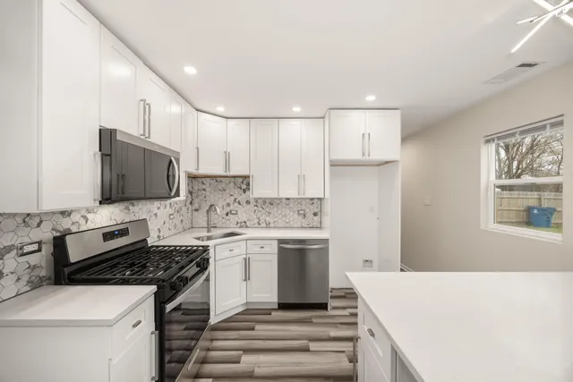 a kitchen with a stove and a refrigerator