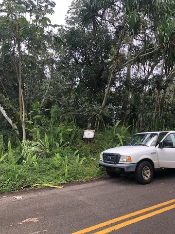a view of a road with a building in the background