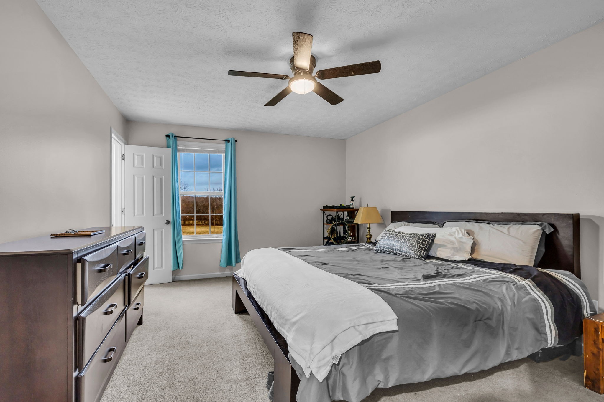 493 Goshen Road Lebanon, TN 37087 - Photo 16 of 29 a bedroom with a bed and a chandelier