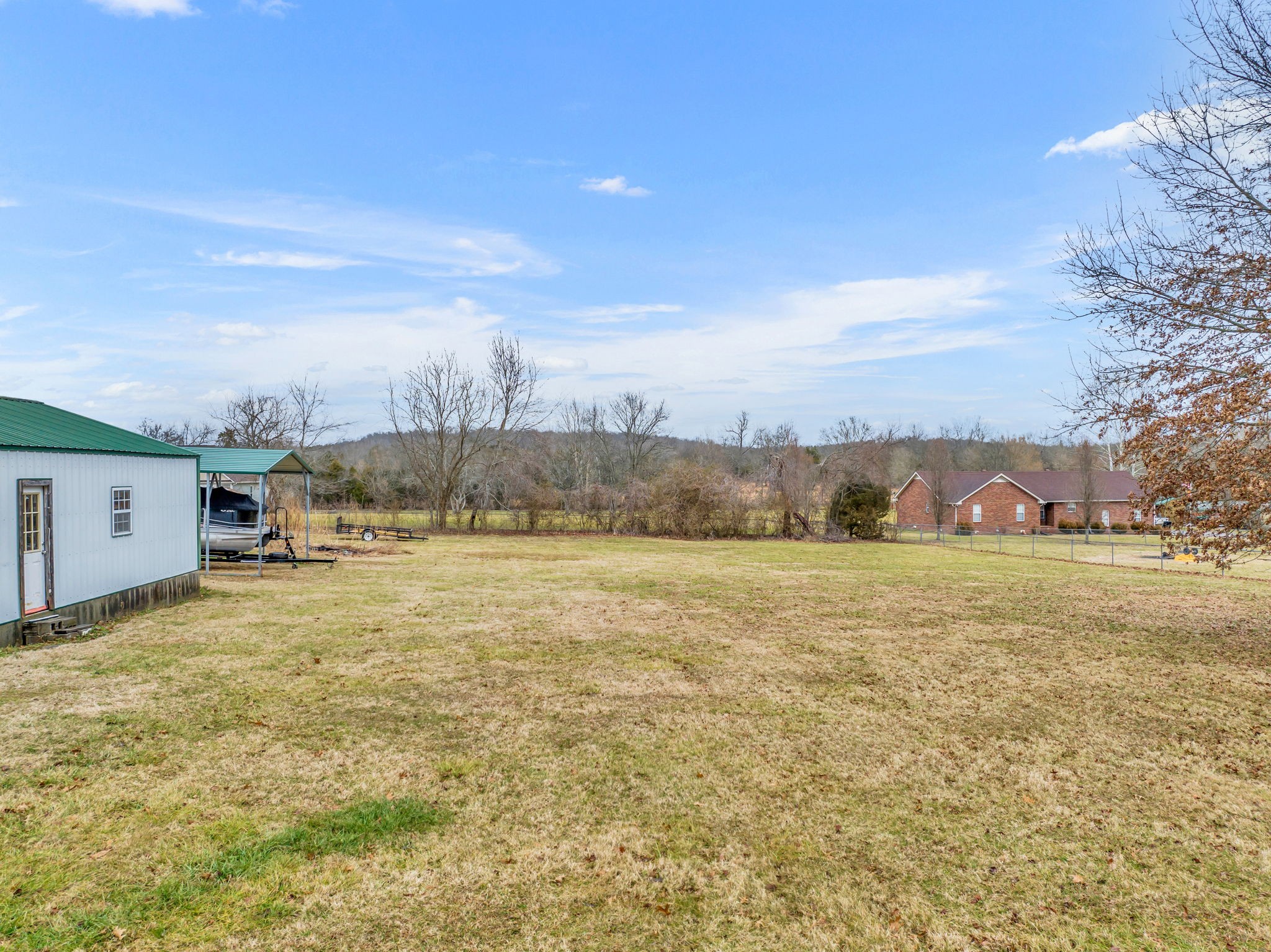 493 Goshen Road Lebanon, TN 37087 - Photo 4 of 29 a view of a big yard with an buildings in back