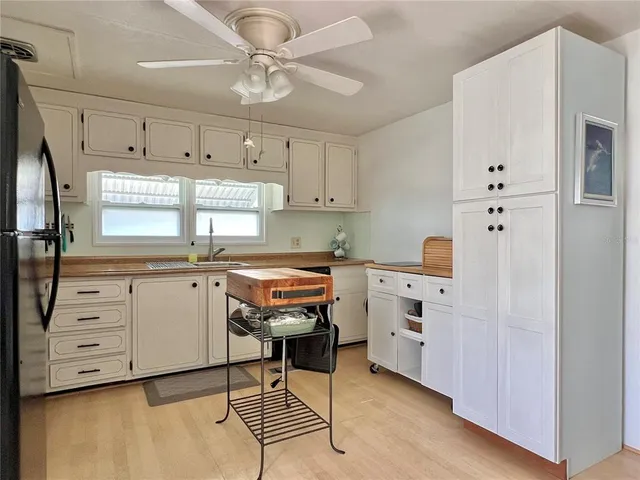 a kitchen with a stove cabinets and window
