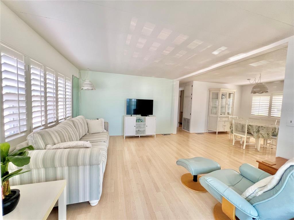 1100 South Belcher Road, Unit 57 Largo, FL 33771 - Photo 14 of 59 a living room with furniture and a flat screen tv