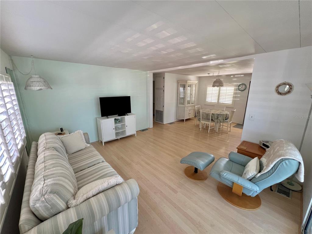 1100 South Belcher Road, Unit 57 Largo, FL 33771 - Photo 15 of 59 a living room with furniture and a flat screen tv