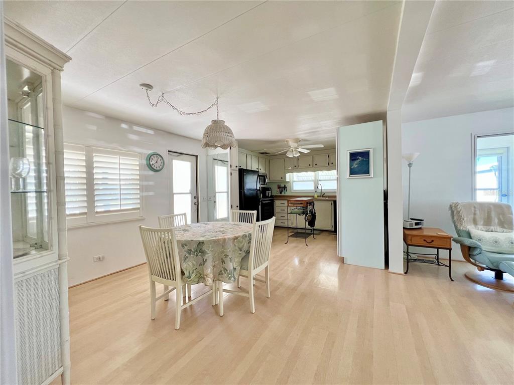 1100 South Belcher Road, Unit 57 Largo, FL 33771 - Photo 17 of 59 a view of a dining room with furniture window and wooden floor