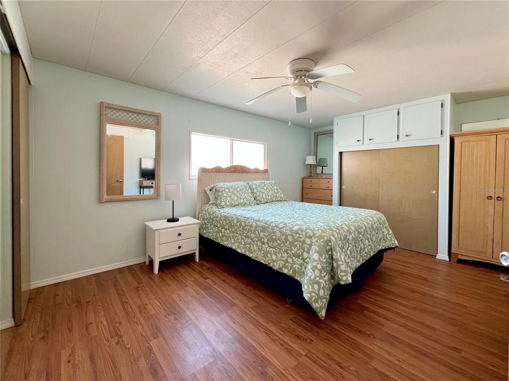 1100 South Belcher Road, Unit 57 Largo, FL 33771 - Photo 21 of 59 a bedroom with a bed and a chandelier
