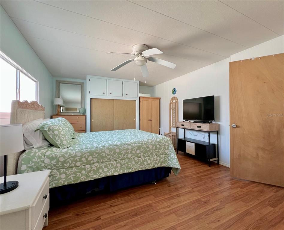 1100 South Belcher Road, Unit 57 Largo, FL 33771 - Photo 22 of 59 a bedroom with a bed and a flat screen tv