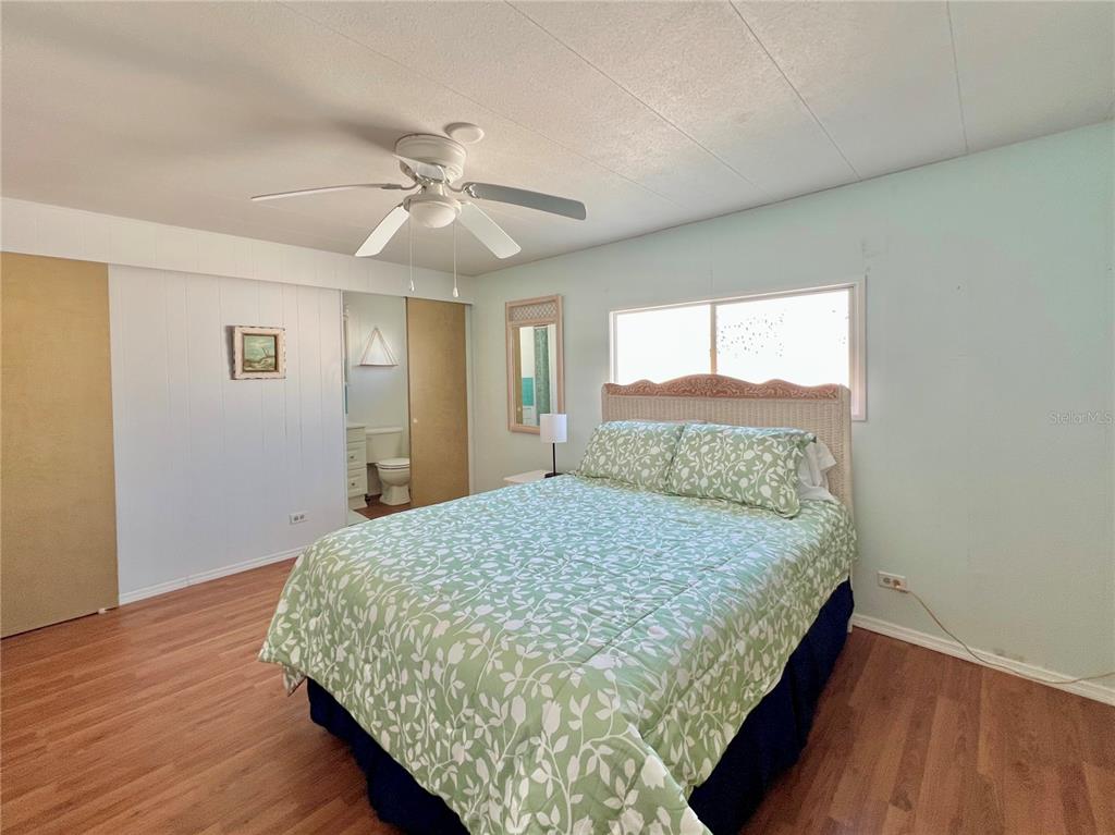 1100 South Belcher Road, Unit 57 Largo, FL 33771 - Photo 23 of 59 a bed sitting in a spacious bedroom next to a window
