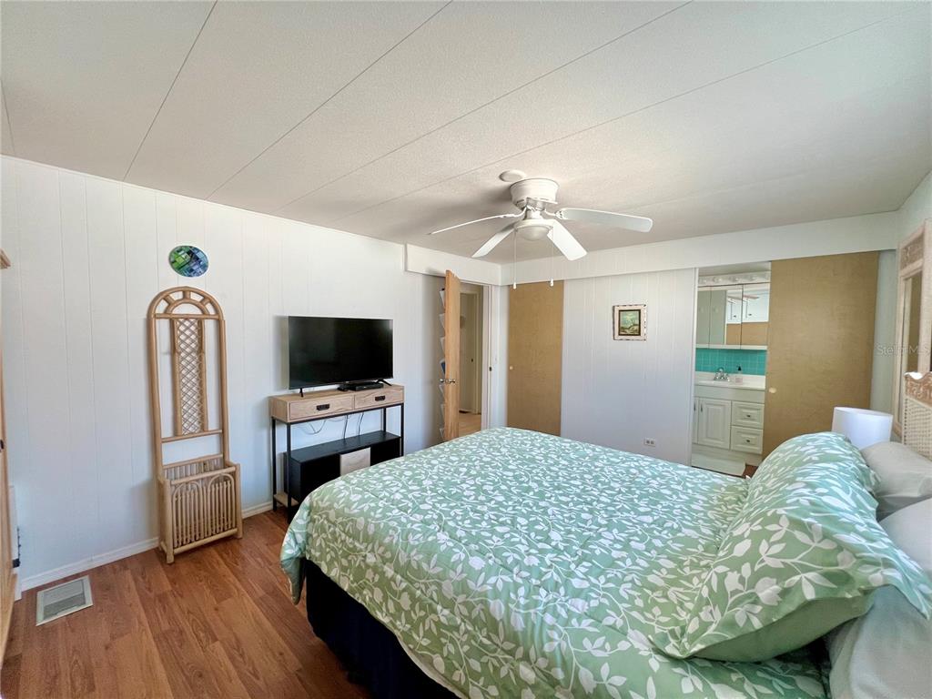 1100 South Belcher Road, Unit 57 Largo, FL 33771 - Photo 24 of 59 a bedroom with a bed and a flat screen tv