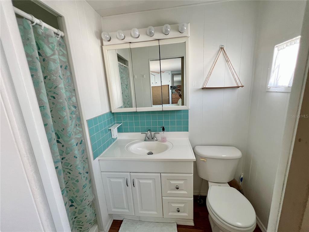 1100 South Belcher Road, Unit 57 Largo, FL 33771 - Photo 25 of 59 a bathroom with a sink a toilet and mirror