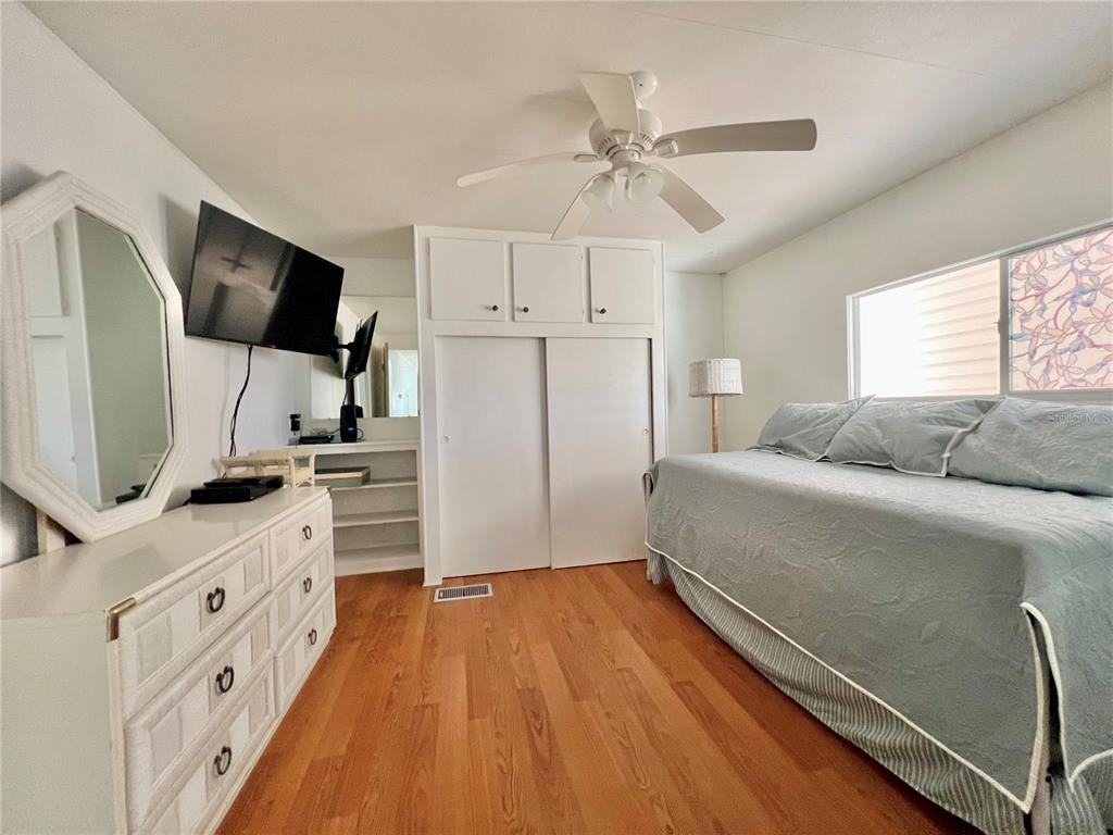 1100 South Belcher Road, Unit 57 Largo, FL 33771 - Photo 28 of 59 a living room with a bed furniture flat screen tv and window
