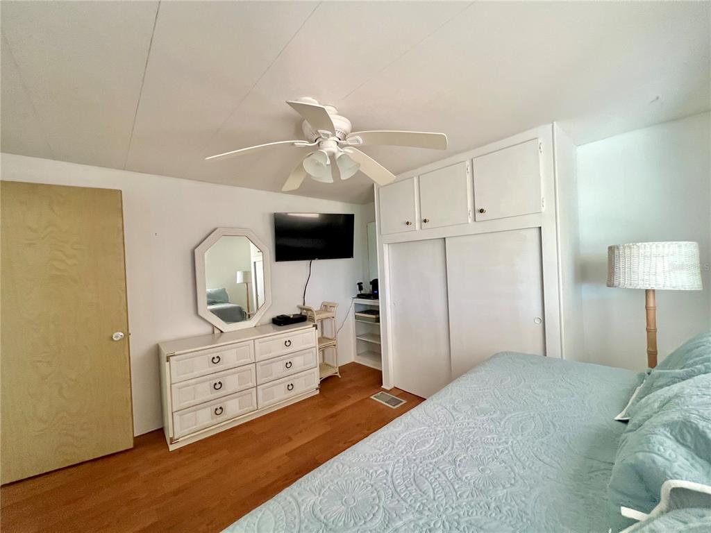 1100 South Belcher Road, Unit 57 Largo, FL 33771 - Photo 29 of 59 a bedroom with a bed and a flat screen tv
