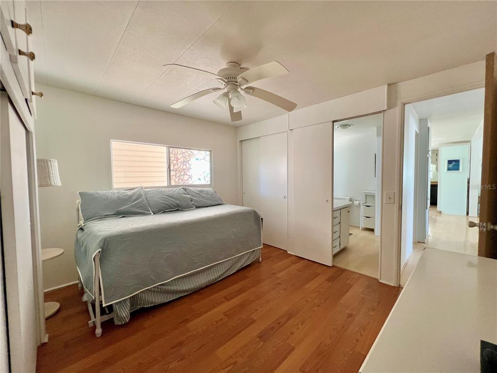 1100 South Belcher Road, Unit 57 Largo, FL 33771 - Photo 30 of 59 a bedroom with a bed and a chandelier