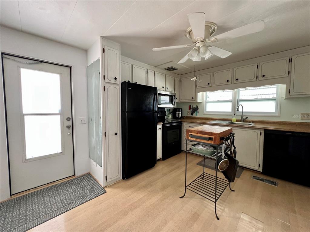 1100 South Belcher Road, Unit 57 Largo, FL 33771 - Photo 37 of 59 a kitchen with stainless steel appliances kitchen island granite countertop a refrigerator stove microwave and cabinets