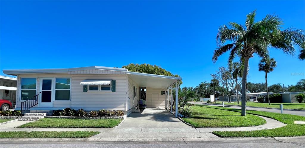 1100 South Belcher Road, Unit 57 Largo, FL 33771 - Photo 38 of 59 a front view of a house with a garden