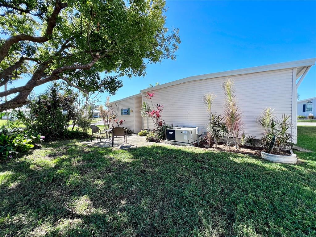 1100 South Belcher Road, Unit 57 Largo, FL 33771 - Photo 40 of 59 a view of backyard with a table and chairs under an umbrella