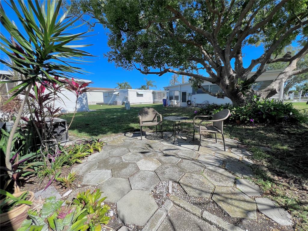 1100 South Belcher Road, Unit 57 Largo, FL 33771 - Photo 41 of 59 a view of a chairs and table in a backyard