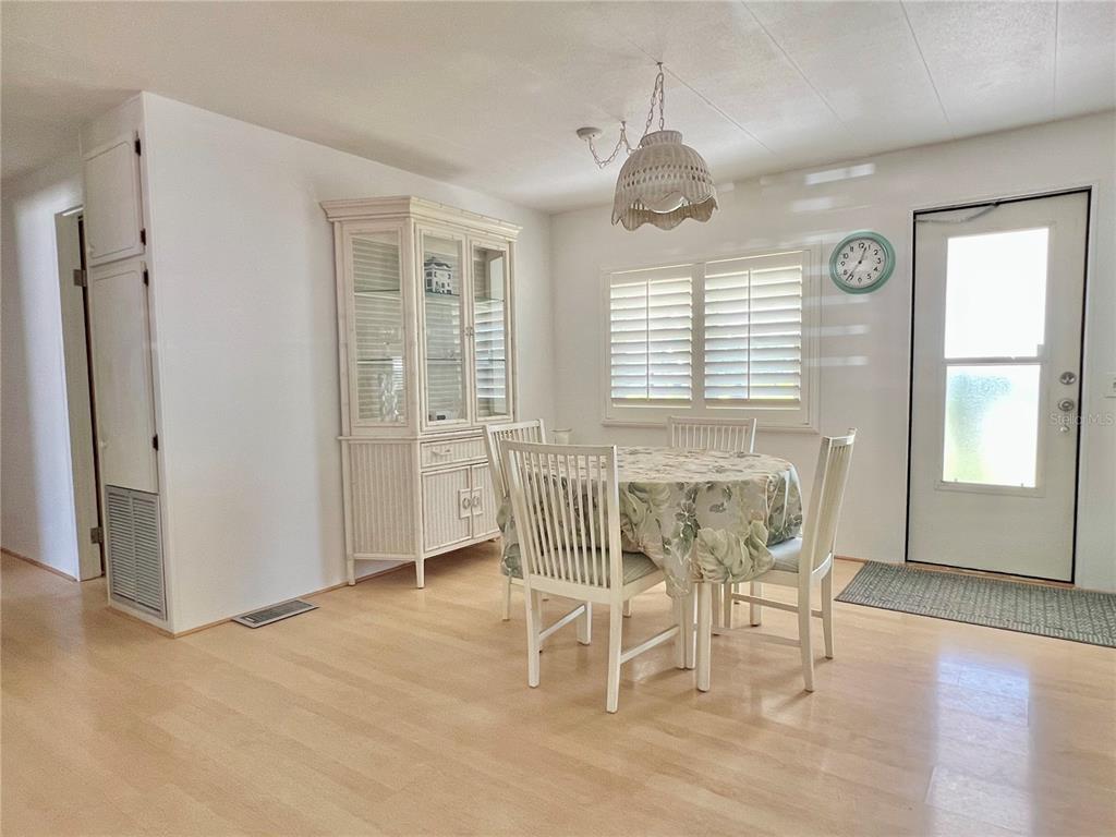 1100 South Belcher Road, Unit 57 Largo, FL 33771 - Photo 5 of 59 a dining room with wooden floor and a window