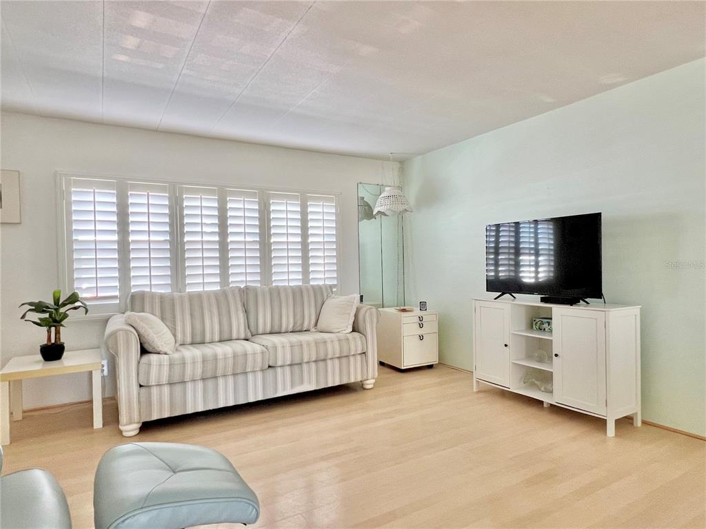 1100 South Belcher Road, Unit 57 Largo, FL 33771 - Photo 6 of 59 a living room with furniture and a flat screen tv