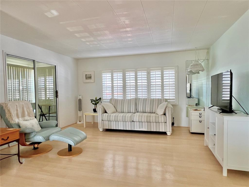 1100 South Belcher Road, Unit 57 Largo, FL 33771 - Photo 7 of 59 a bedroom with furniture and a large window