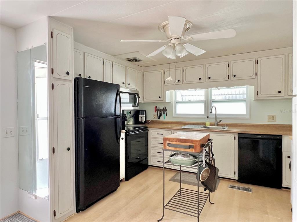 1100 South Belcher Road, Unit 57 Largo, FL 33771 - Photo 9 of 59 a kitchen with stainless steel appliances a stove a refrigerator and a refrigerator