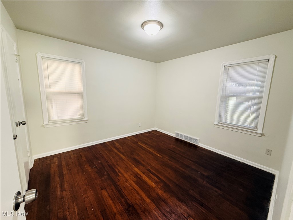 5239 Arch Street Maple Heights, OH 44137 - Photo 9 of 25 Unfurnished room featuring dark wood-style flooring and plenty of natural light