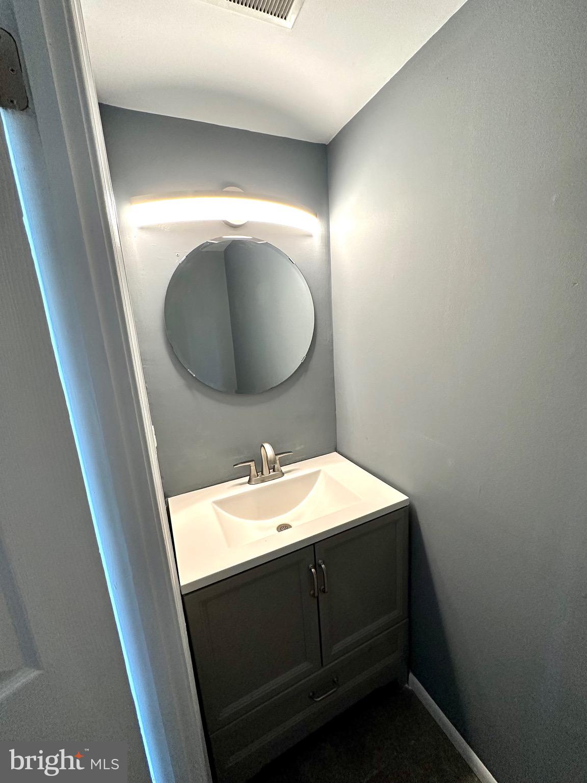 326 Brandon Drive Bear, DE 19701 - Photo 2 of 16 a bathroom with a sink and a mirror