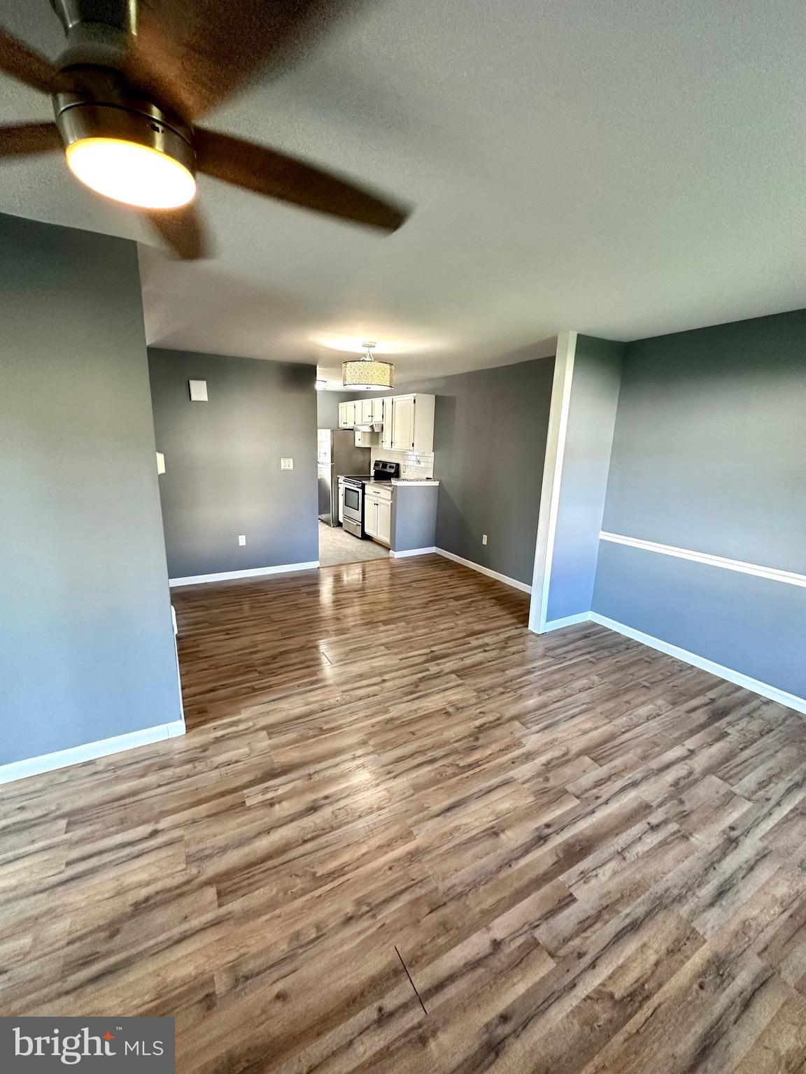 326 Brandon Drive Bear, DE 19701 - Photo 3 of 16 a view of a livingroom with a ceiling fan and wooden floor